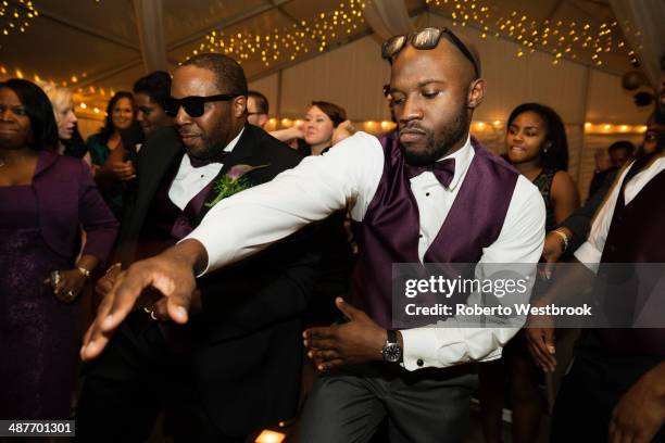 groom and groomsman dancing at reception - wedding reception stock-fotos und bilder