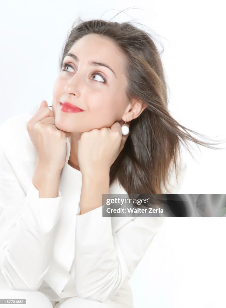 Smiling woman resting chin on hands