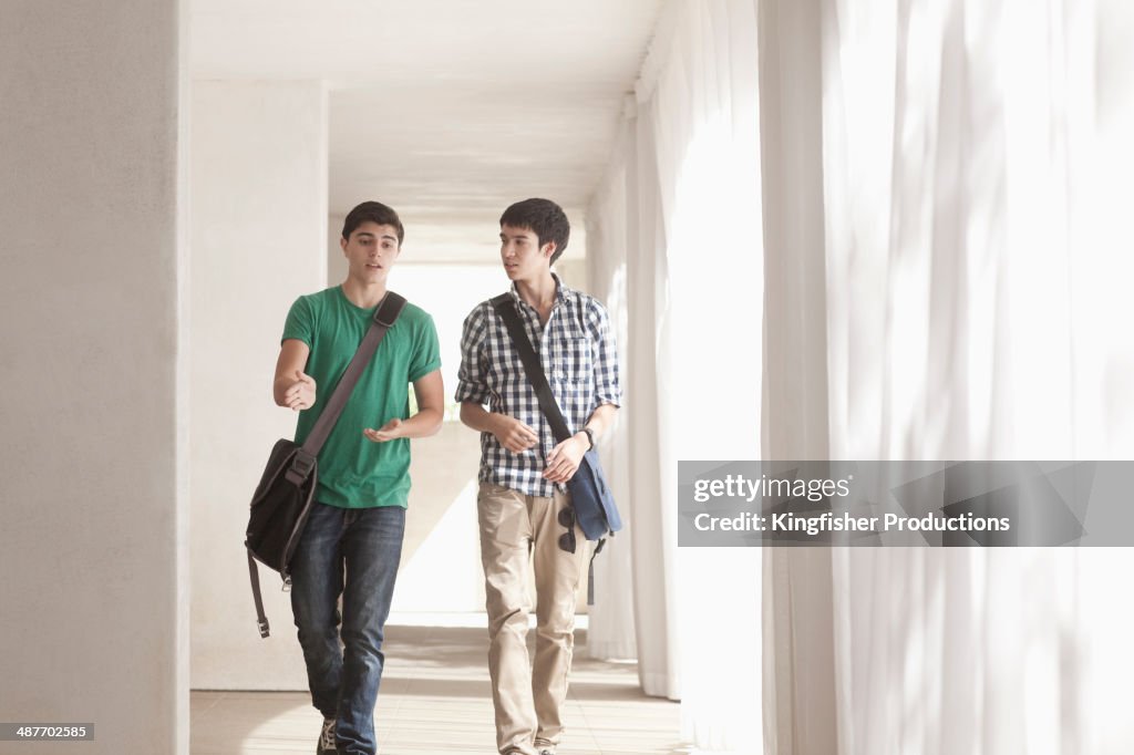 Teenage boys talking in corridor