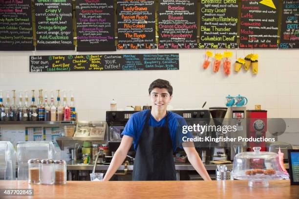 mixed race teenage boy working in cafe - part time job stockfoto's en -beelden