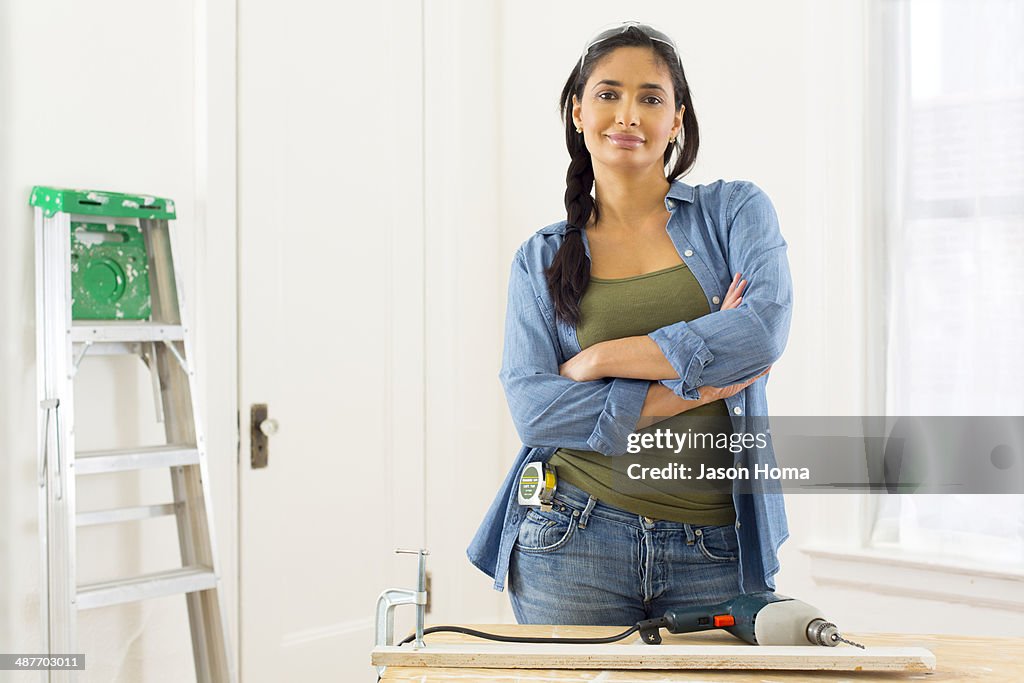 Mixed race contractor working in shop