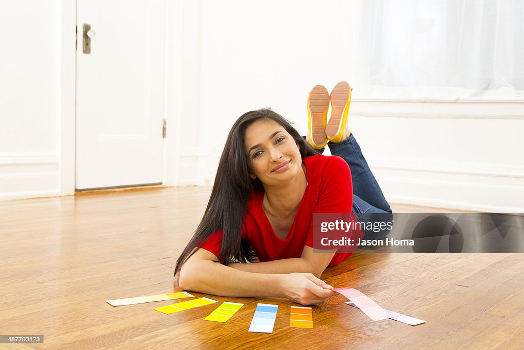 Mixed race woman examining paint swatches