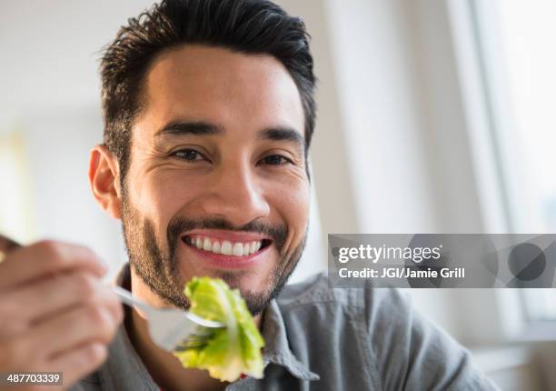 mixed race man eating salad - indian food bildbanksfoton och bilder