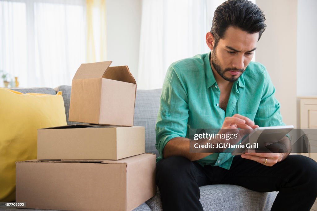 Mixed race man using digital tablet and moving