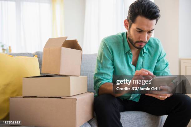 Mixed Race Man Using Digital Tablet And Moving, 照片檔