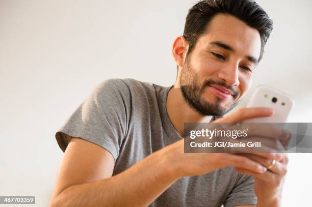 mixed race man using cell phone - mobile phone reading low angle stock pictures, royalty-free photos & images