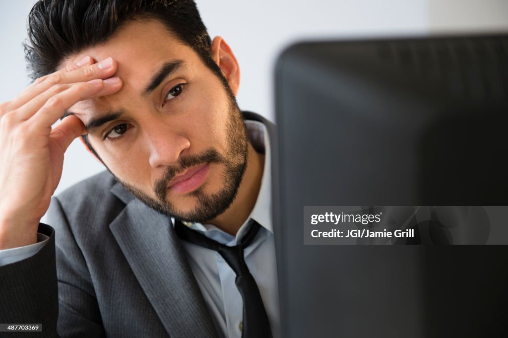 Mixed race businessman working in office