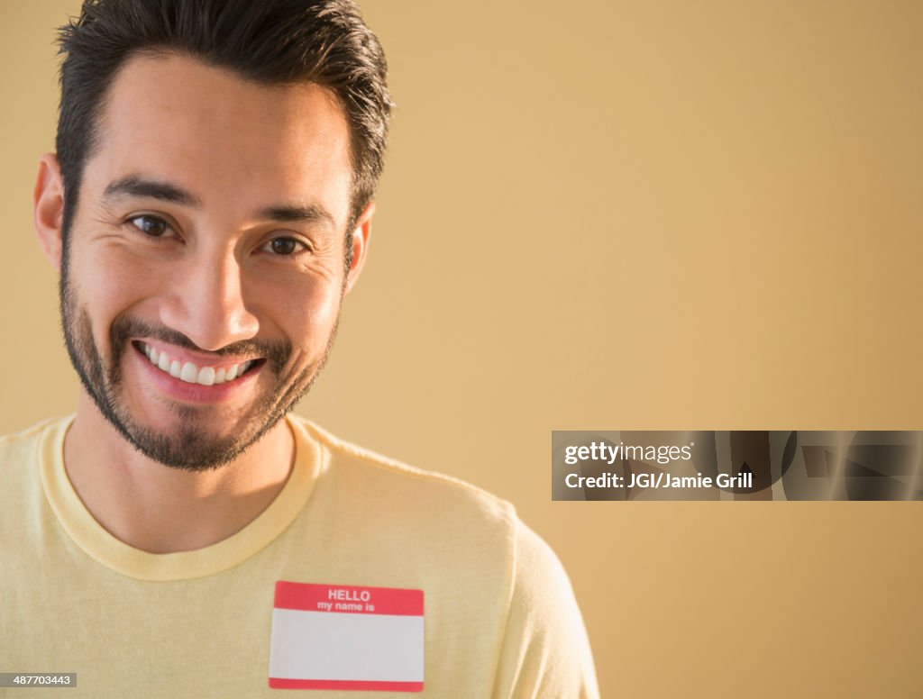 Mixed race man wearing name tag