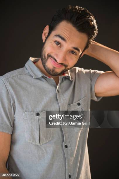 mixed race man smiling - mixed race man standing studio stockfoto's en -beelden