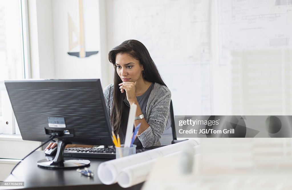 Hispanic businesswoman working in office