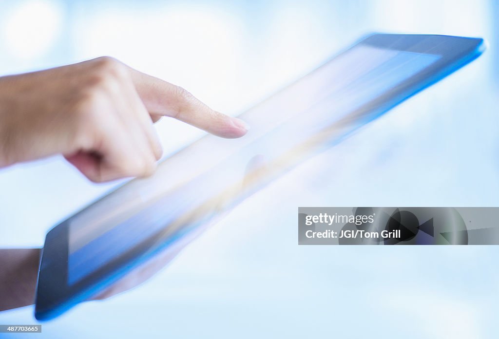 Hispanic woman using digital tablet