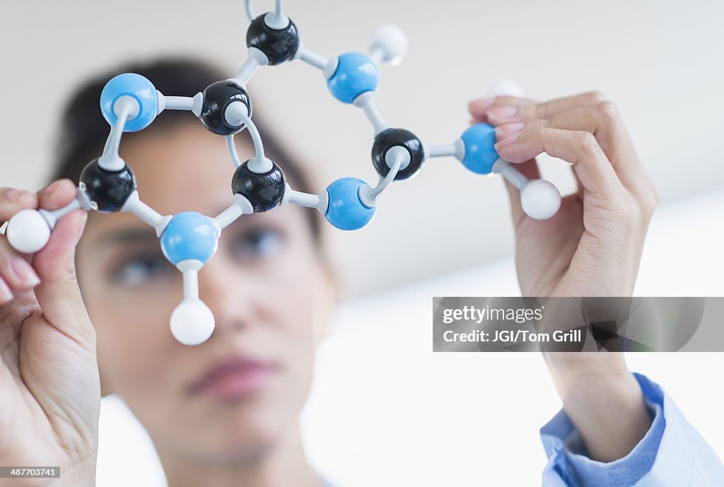 Hispanic scientist examining molecular model