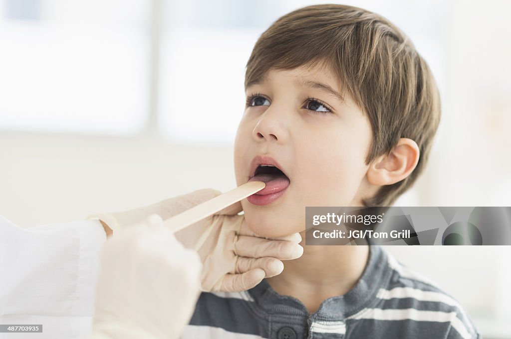 Hispanic boy getting a check up at doctor's office