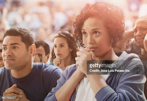 tense spectators watching sporting event - anticipation sport stock pictures, royalty-free photos & images