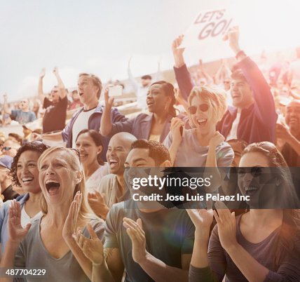 Spectators cheering at sporting event Spectators cheering at sporting event