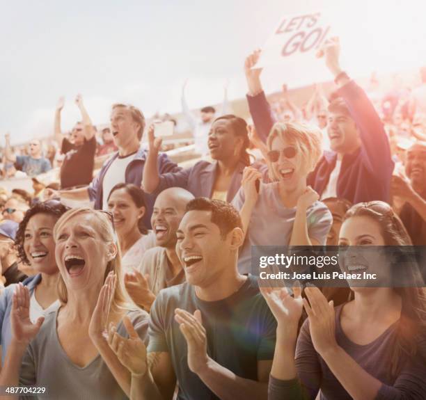 spectators cheering at sporting event - focus on sport 2012 stock pictures, royalty-free photos & images