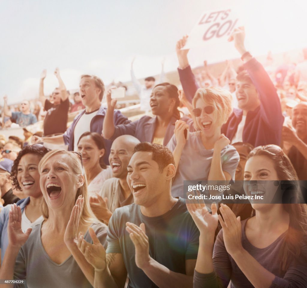 Spectators cheering at sporting event