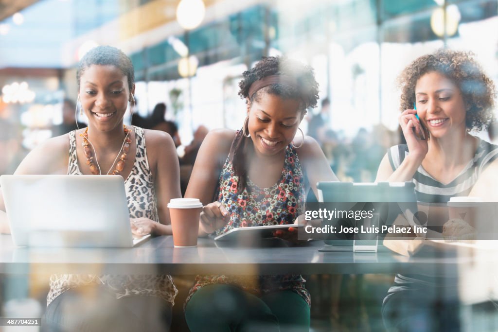 Women using technology in cafe