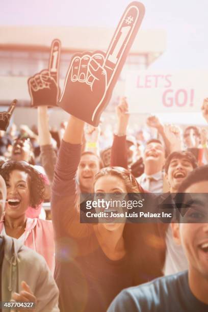 spectators cheering at sporting event - foam hand imagens e fotografias de stock