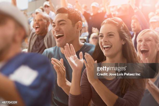 couple cheering at sporting event - focus on sport 2012 stock pictures, royalty-free photos & images