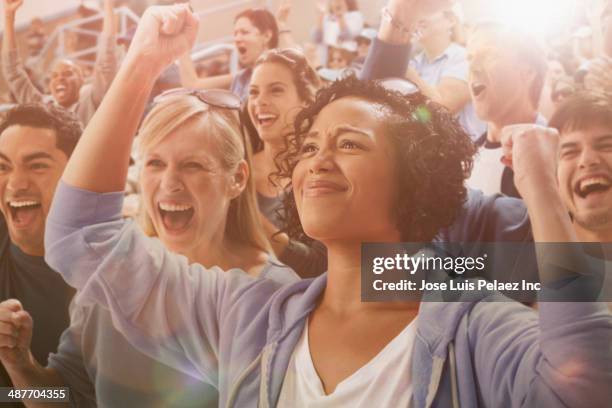 spectators cheering at sporting event - bleachers stock pictures, royalty-free photos & images