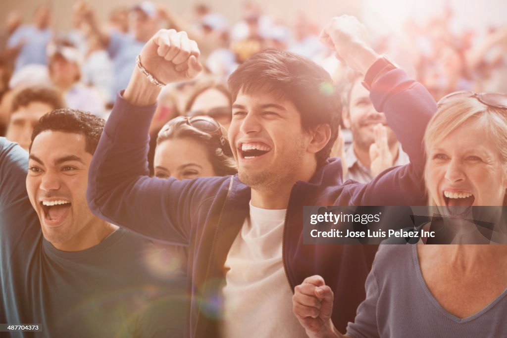 Spectators cheering at sporting event