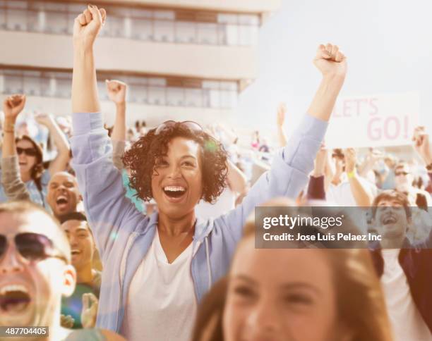 spectators cheering at sporting event - fan women stock-fotos und bilder