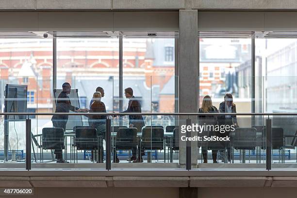 boardroom meeting - distant meeting stock pictures, royalty-free photos & images