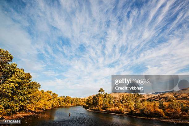 dramatic clouds over boise river in idaho - boise stock pictures, royalty-free photos & images