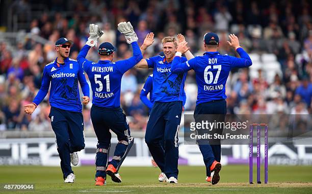 England bowler David Willey celebrates with team mates after dismissing Steven Smith during the 4th Royal London One-Day International match between...