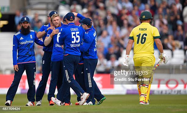 England bowler David Willey celebrates with team mates after dismissing Australia batsman Aaron Finch during the 4th Royal London One-Day...