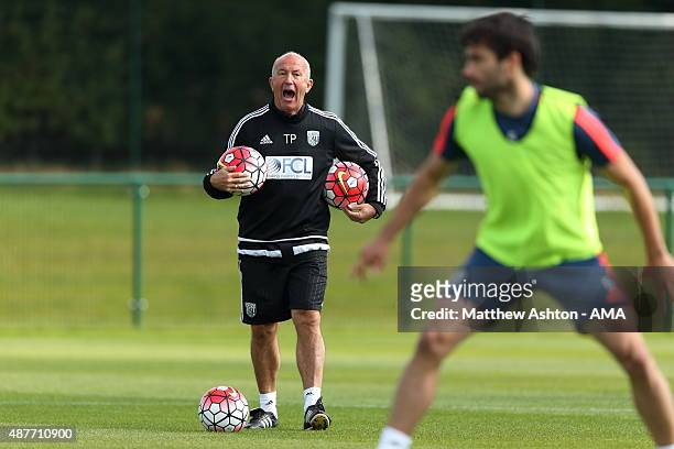 Tony Pulis the head coach / manager of West Bromwich Albion talks to his players during the training session during the West Bromwich Albion training...
