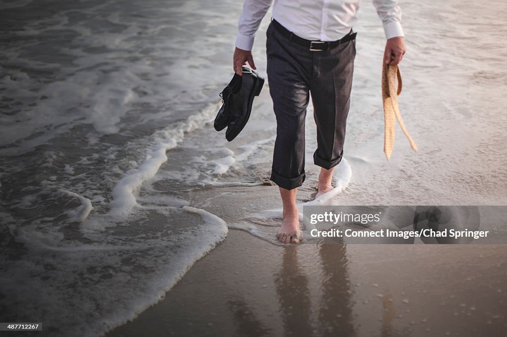 Retired businessman paddling in sea