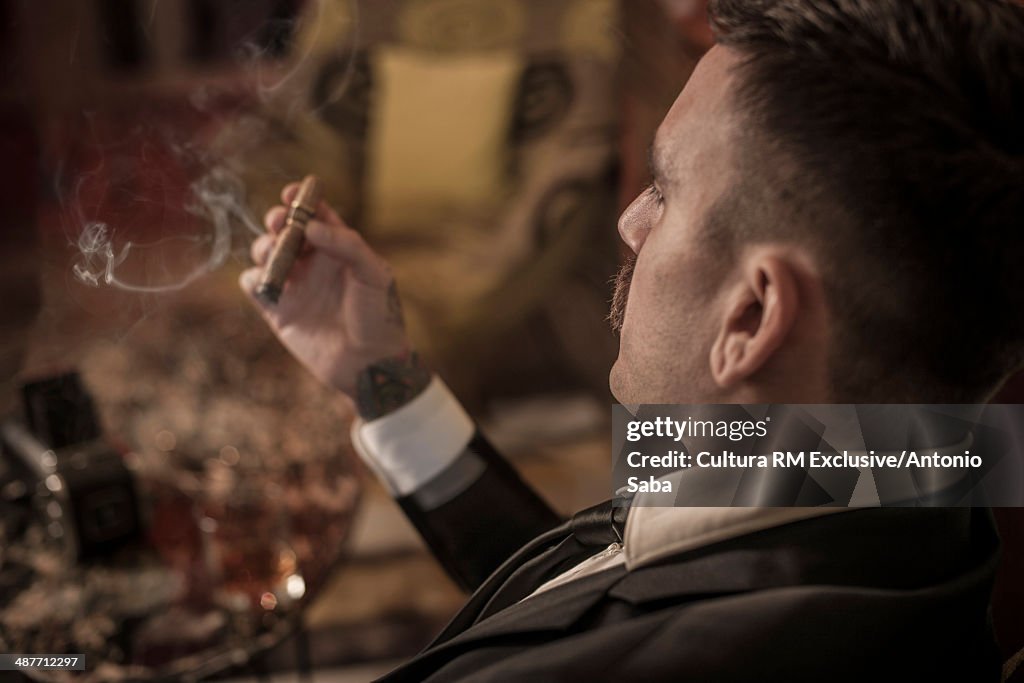 Backview of man enjoying cigar