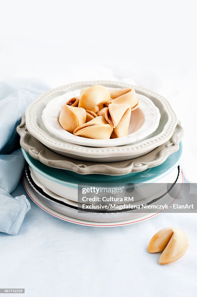 Fortune cookies on stack of plates