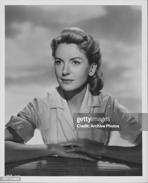 Portrait of actress Deborah Kerr wearing a white dress and pearls, circa 1960.