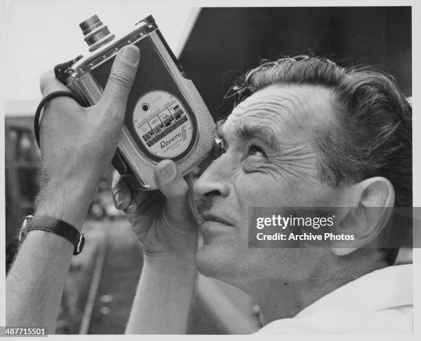 English director David Lean, pictured on the set of a film using a hand held Revere 16mm camera, circa 1950-1965.
