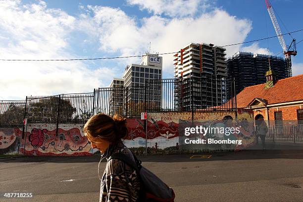 Pedestrian walks past a mural featuring Aboriginal dot painting on Eveleigh Street in the inner city suburb of Redfern in Sydney, Australia, on...