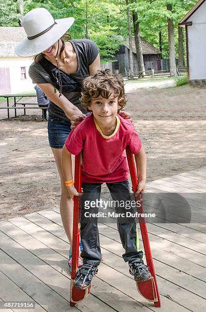young boy walking with stilts - styltor bildbanksfoton och bilder