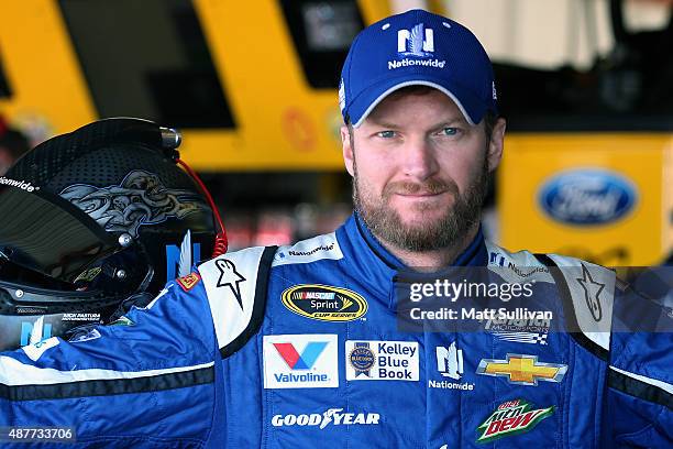 Dale Earnhardt Jr., driver of the Nationwide Chevrolet, stands in the garage area during practice for the NASCAR Sprint Cup Series Federated Auto...