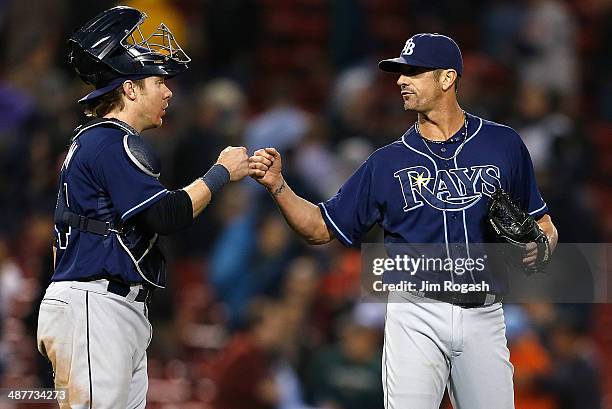 Grant Balfour and Ryan Hanigan of the Tampa Bay Rays celebrate a win against the Boston Red Sox, 6-5, in game two of a doubleheader at Fenway Park...