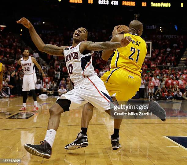 Forward David West of the Indiana Pacers grabs the ball behind guard Jeff Teague of the Atlanta Hawks in Game 6 of the Eastern Conference...