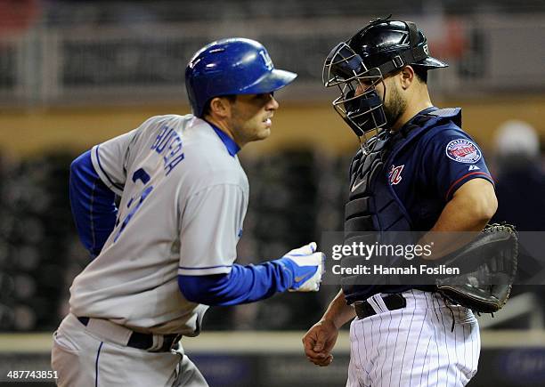 Josmil Pinto of the Minnesota Twins looks on as Drew Butera of the Los Angeles Dodgers crosses home plate after hitting a solo home run during the...