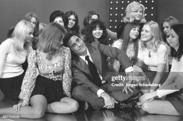 French singer Gilbert Bécaud surrounded by female fans during a visit to West Berlin, Germany, 1971.