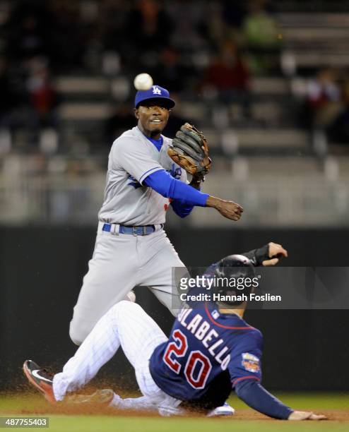 Dee Gordon of the Los Angeles Dodgers gets Chris Colabello of the Minnesota Twins out at second base as Gordon turns a double-play during the sixth...