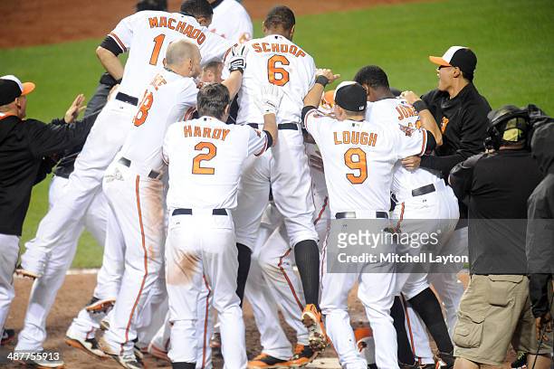 The Baltimore Orioles celebrate a walk off home run by Matt Wieters in the tenth inning during a baseball game against the Pittsburgh Pirates in game...