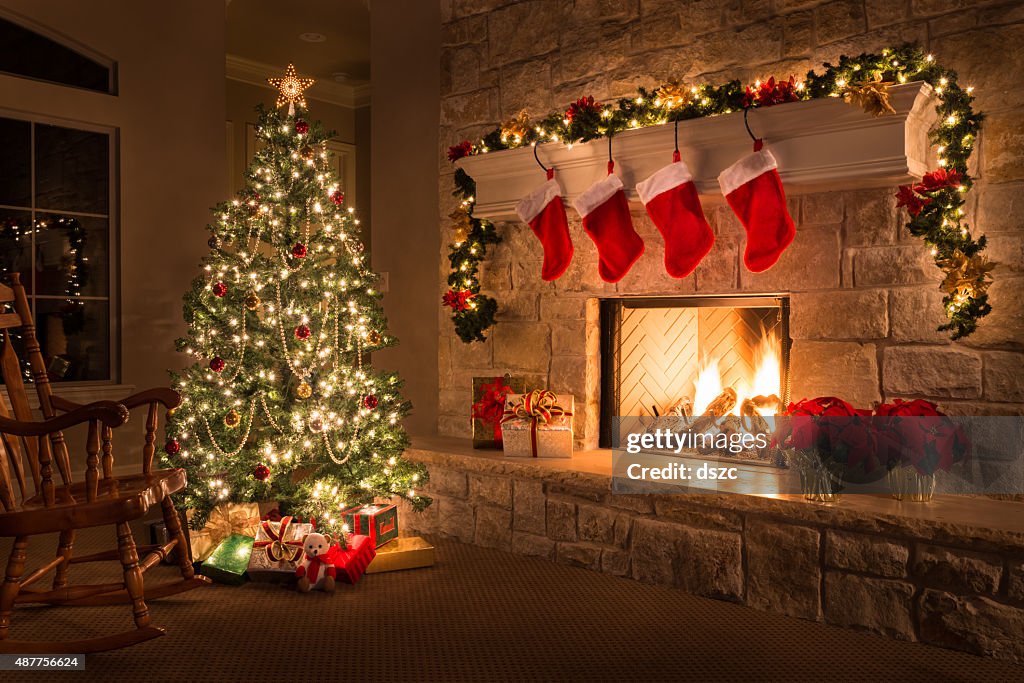 Christmas. Glowing fireplace, hearth, tree. Red stockings. Gifts and decorations.