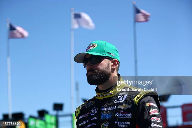 Paul Menard, driver of the Libman/Menards Chevrolet, walks through the garage area during practice for the NASCAR Sprint Cup Series Federated Auto...