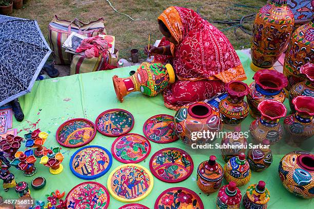 Woman is busy colouring earthenware. Pottery is quite famous in West Bengal. The small-scale industry of pottery is carried on mainly in the three...