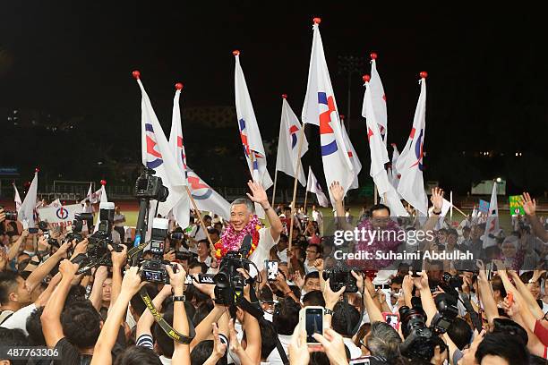 Prime Minister and People's Action Party Secretary General, Lee Hsien Loong and Dr Koh Poh Koon celebrate after winning their seat for Ang Mo Kio...